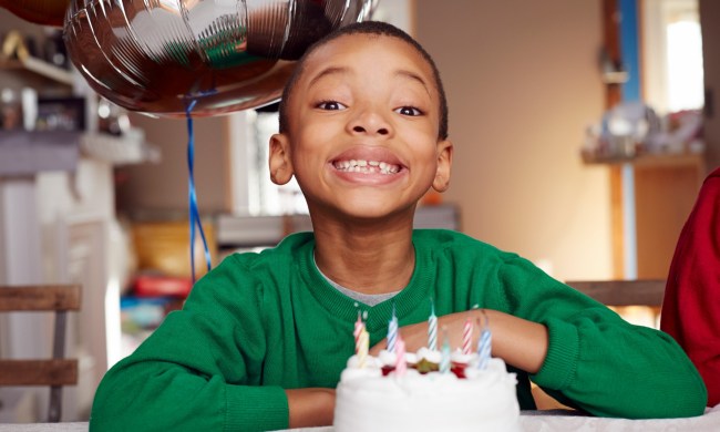 Smiling child with birthday cake