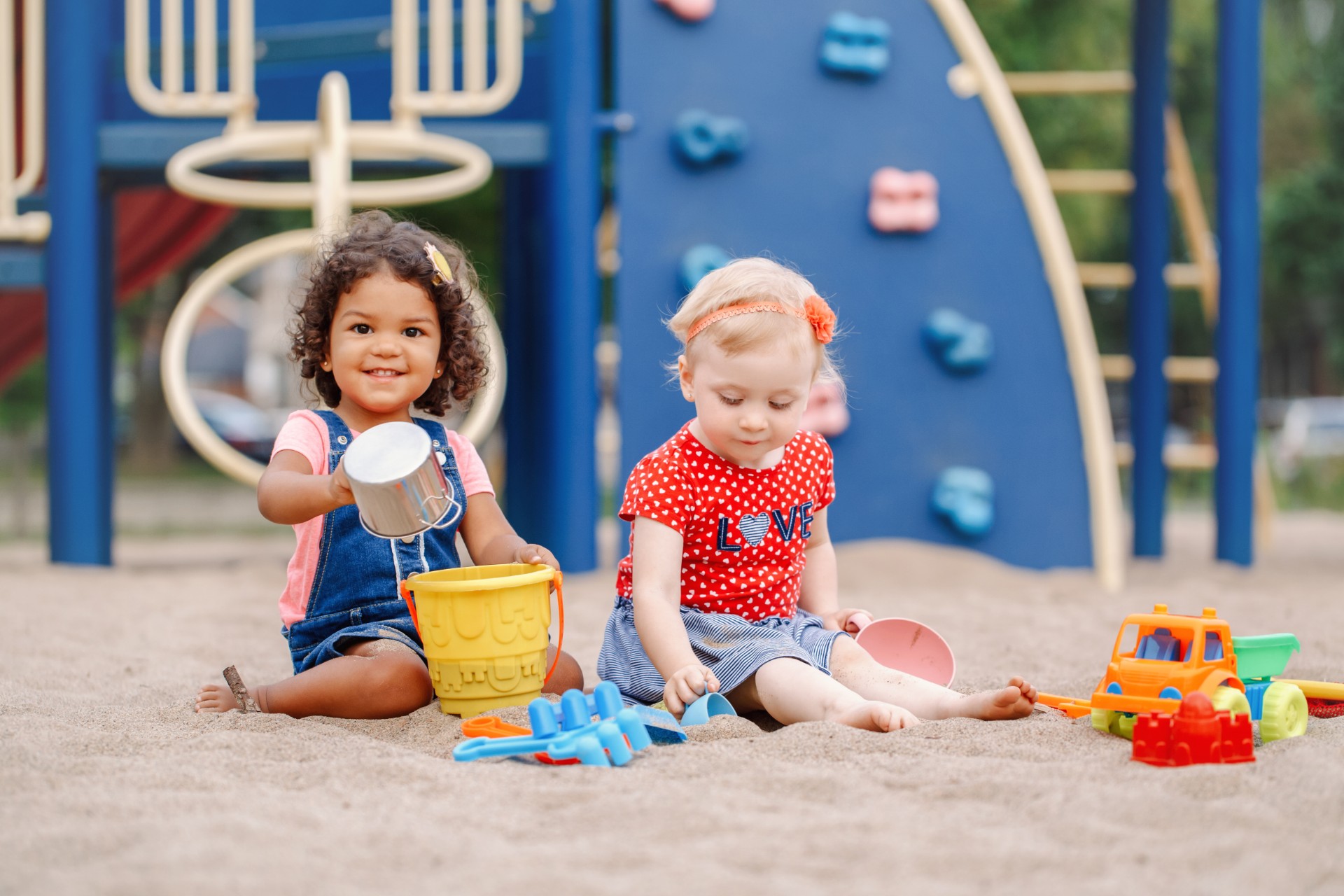 Two toddlers playing at a playground