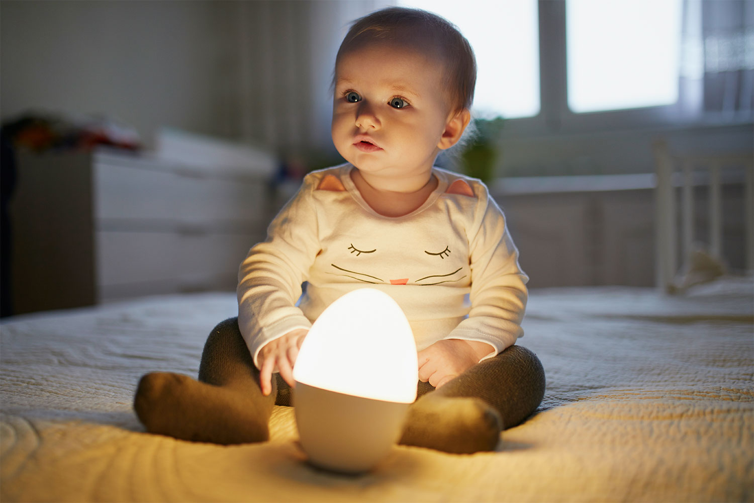 Cute baby playing with night light