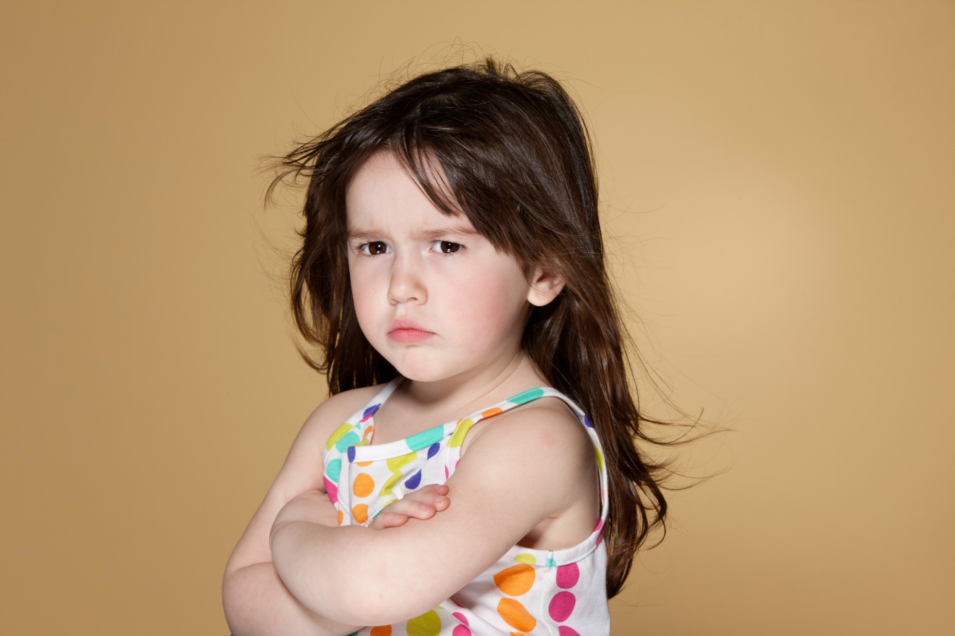 Little girl in dress frowning