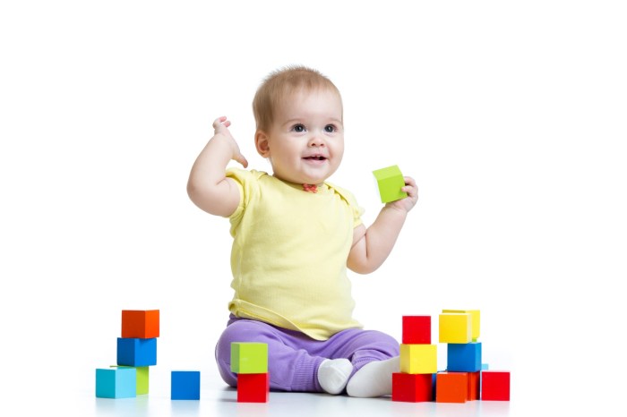 Baby playing with multicolored blocks
