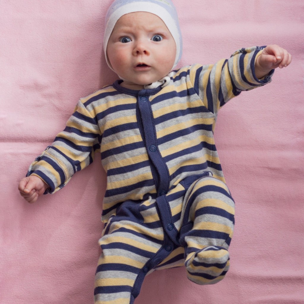 Baby in striped onesie lying down
