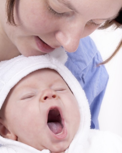 Mother sings to yawning baby
