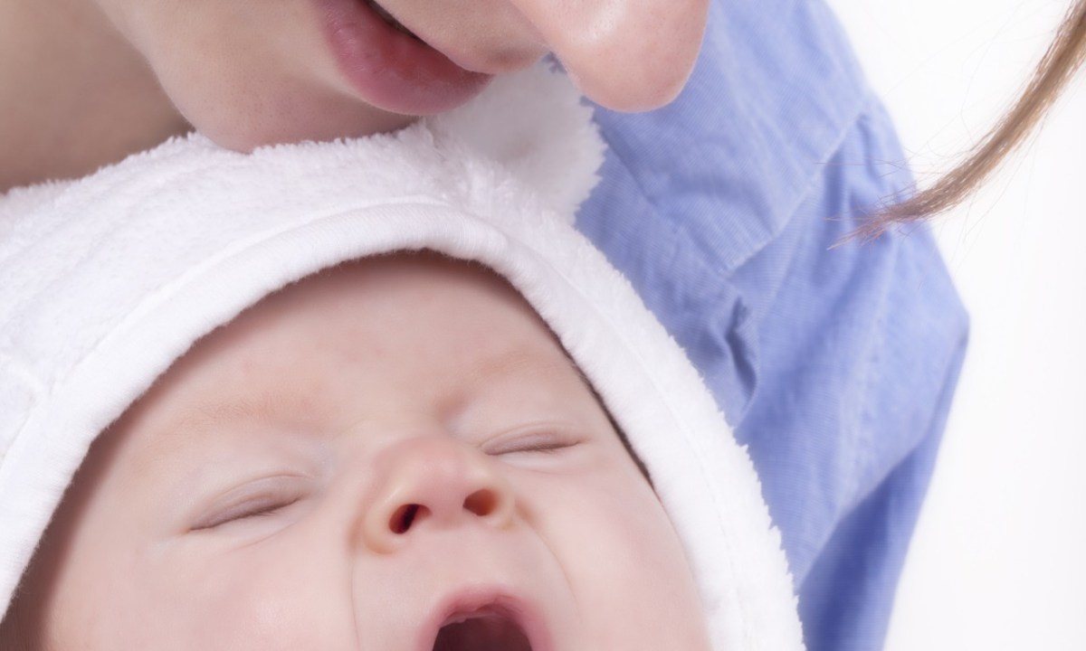 Mother sings to yawning baby