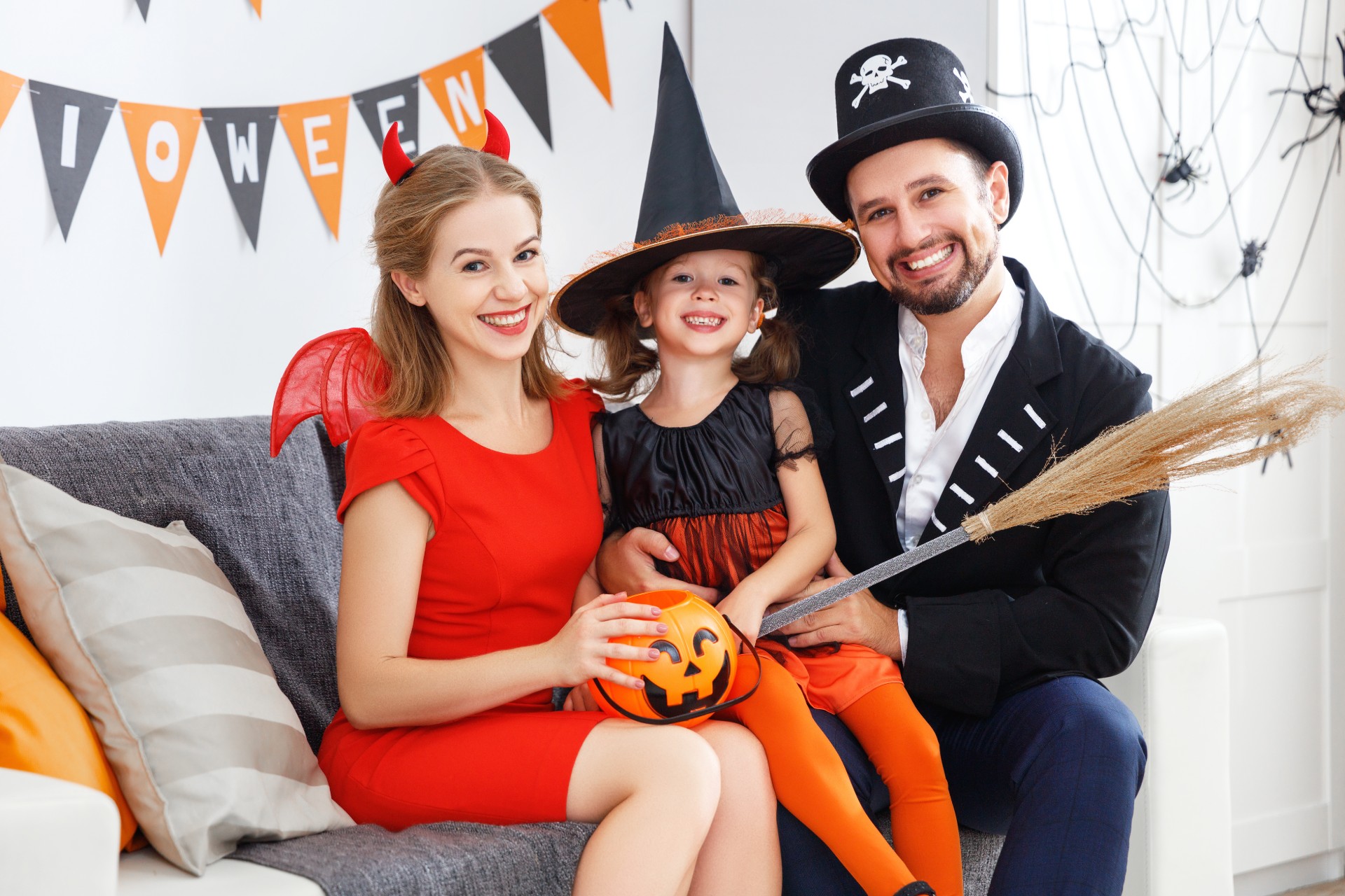 Mother and father with daughter in Halloween costumes