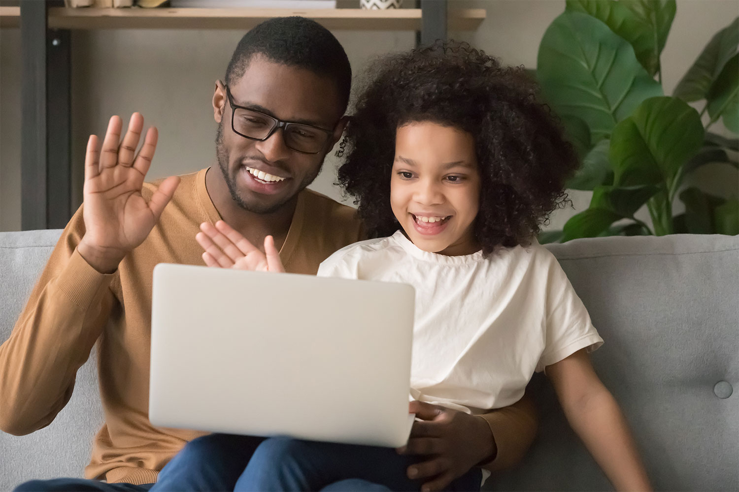 father and daughter watching a video together
