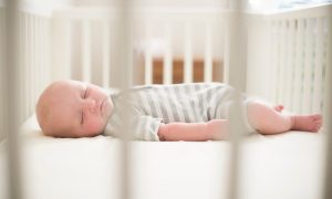 A baby sleeping in a crib