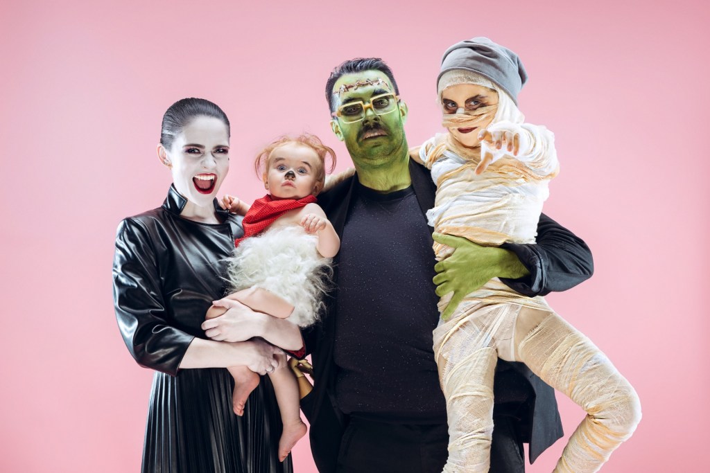 Family of four dressed in Halloween costumes.