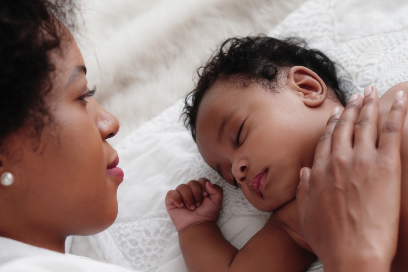 Mother lying next to sleeping toddler son.