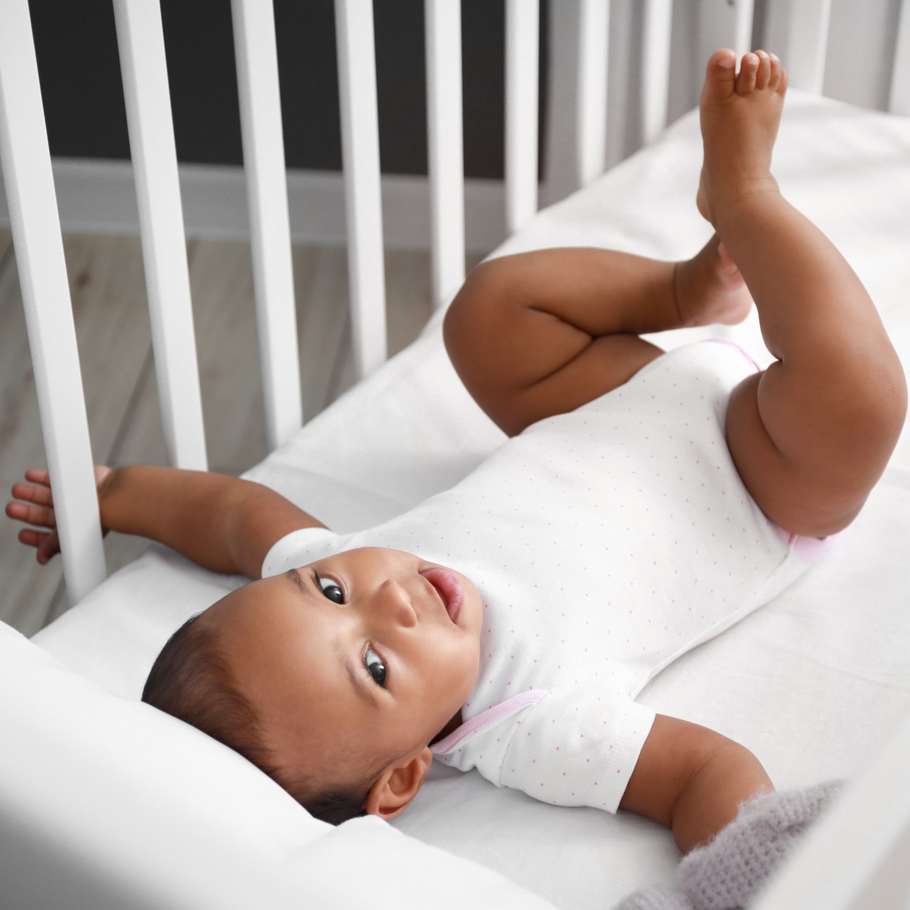 Baby boy lying in crib