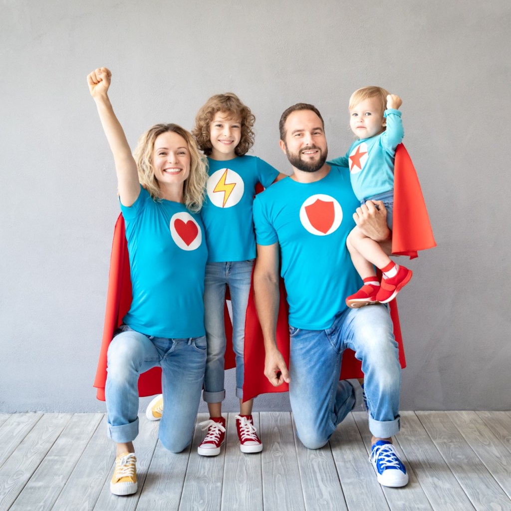 Family of four dressed as superheroes.