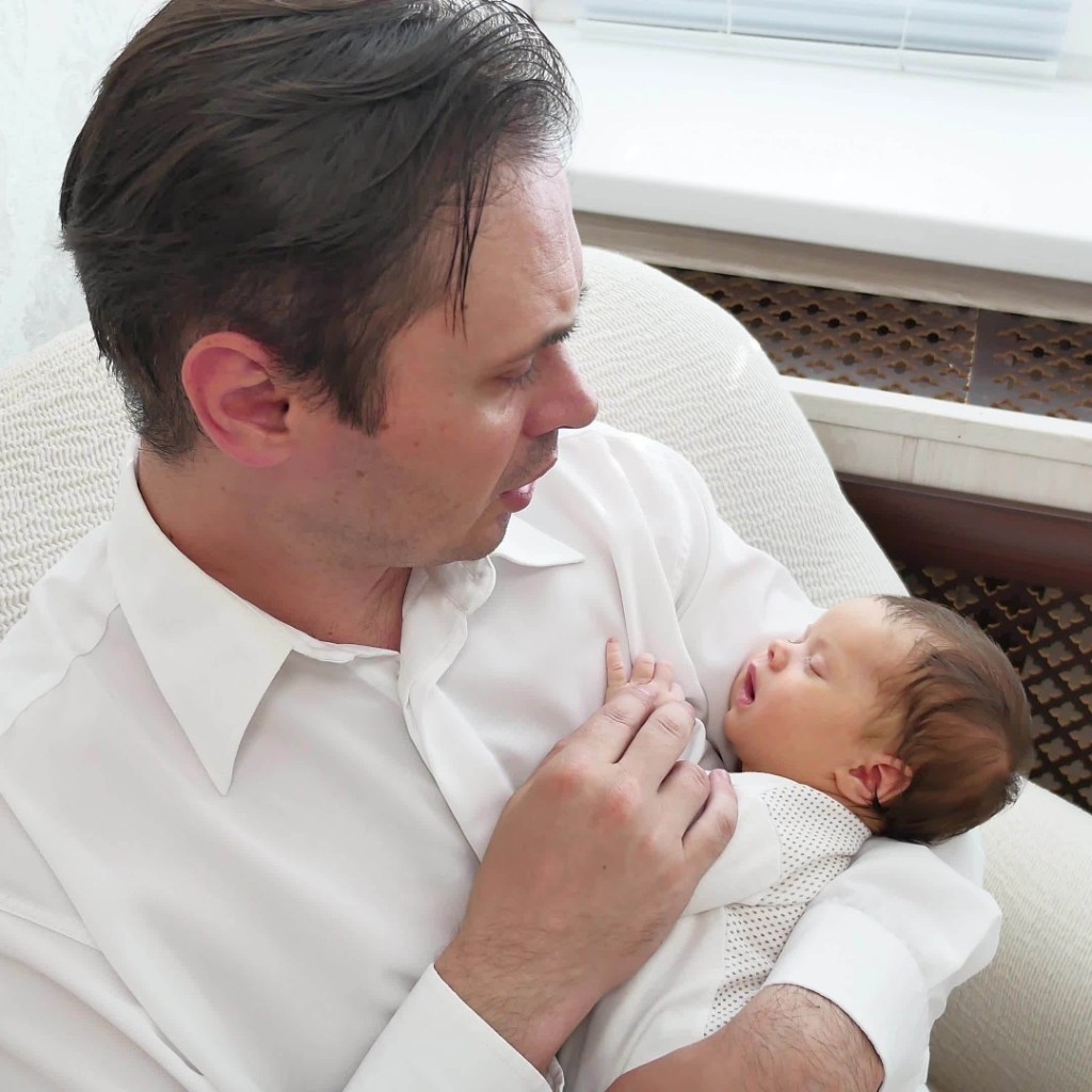 Father sings lullaby to child