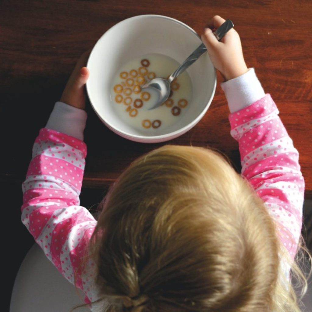 A small child eating cereal