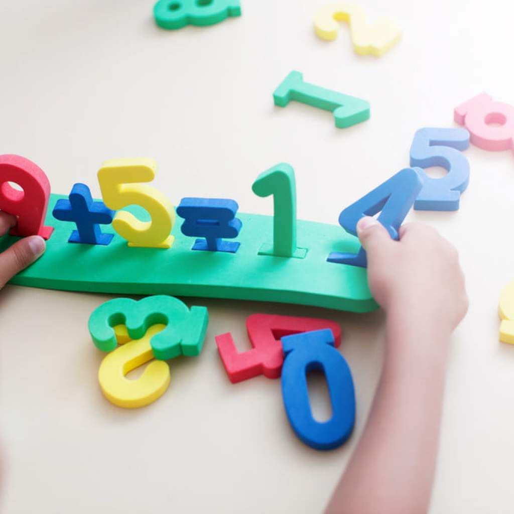 Child playing with colored numbers