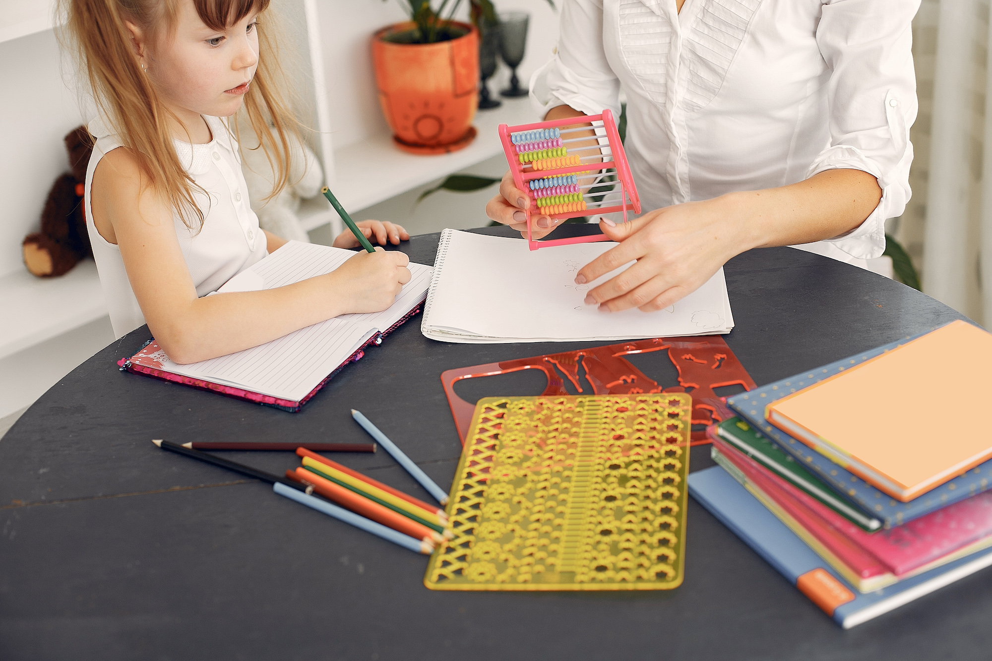 child learning to count at table with schoolwork