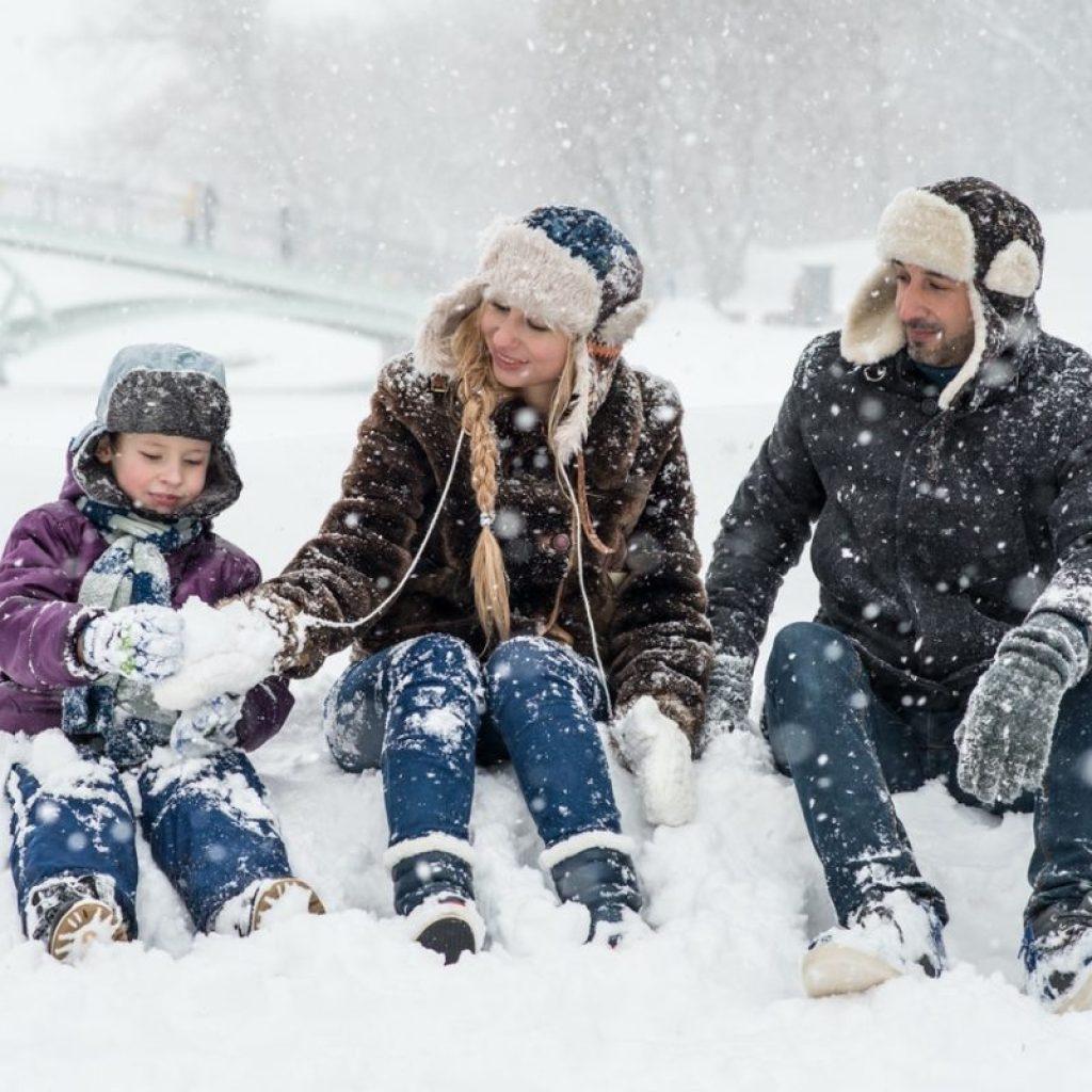 Family sitting in snow
