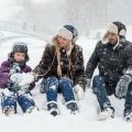 A family playing together in the snow