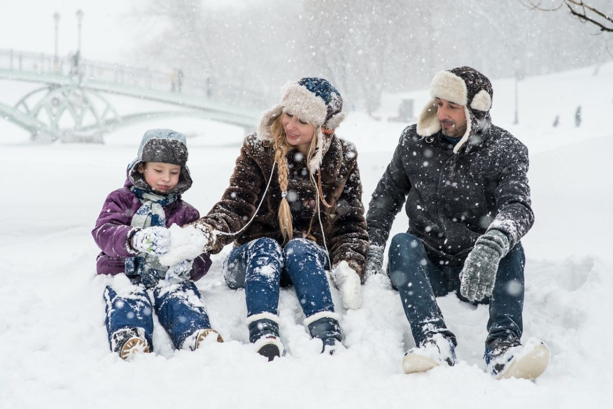 A family playing together in the snow