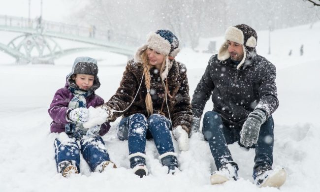 A family playing together in the snow