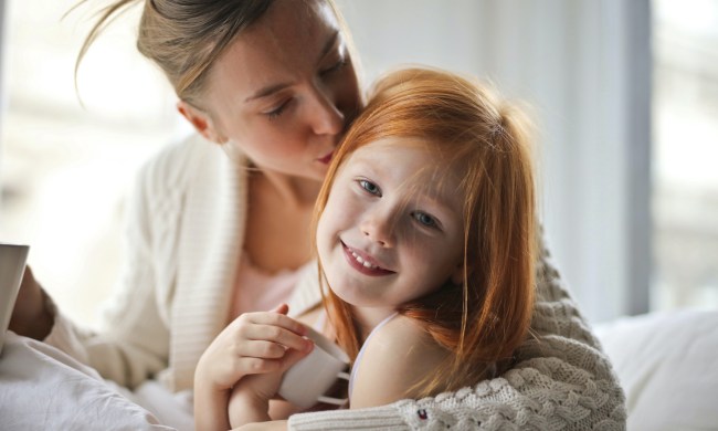 Mother kissing daughter on the head