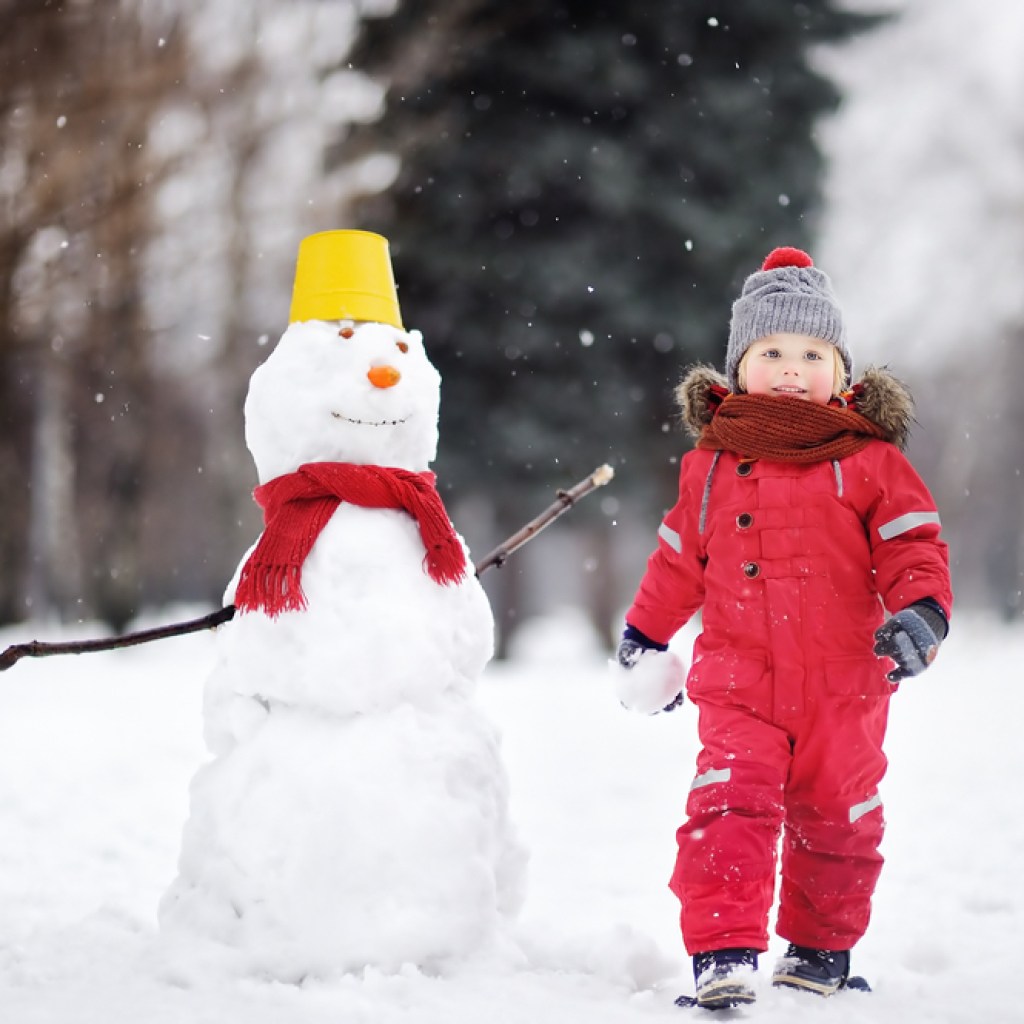 Toddler with snowman