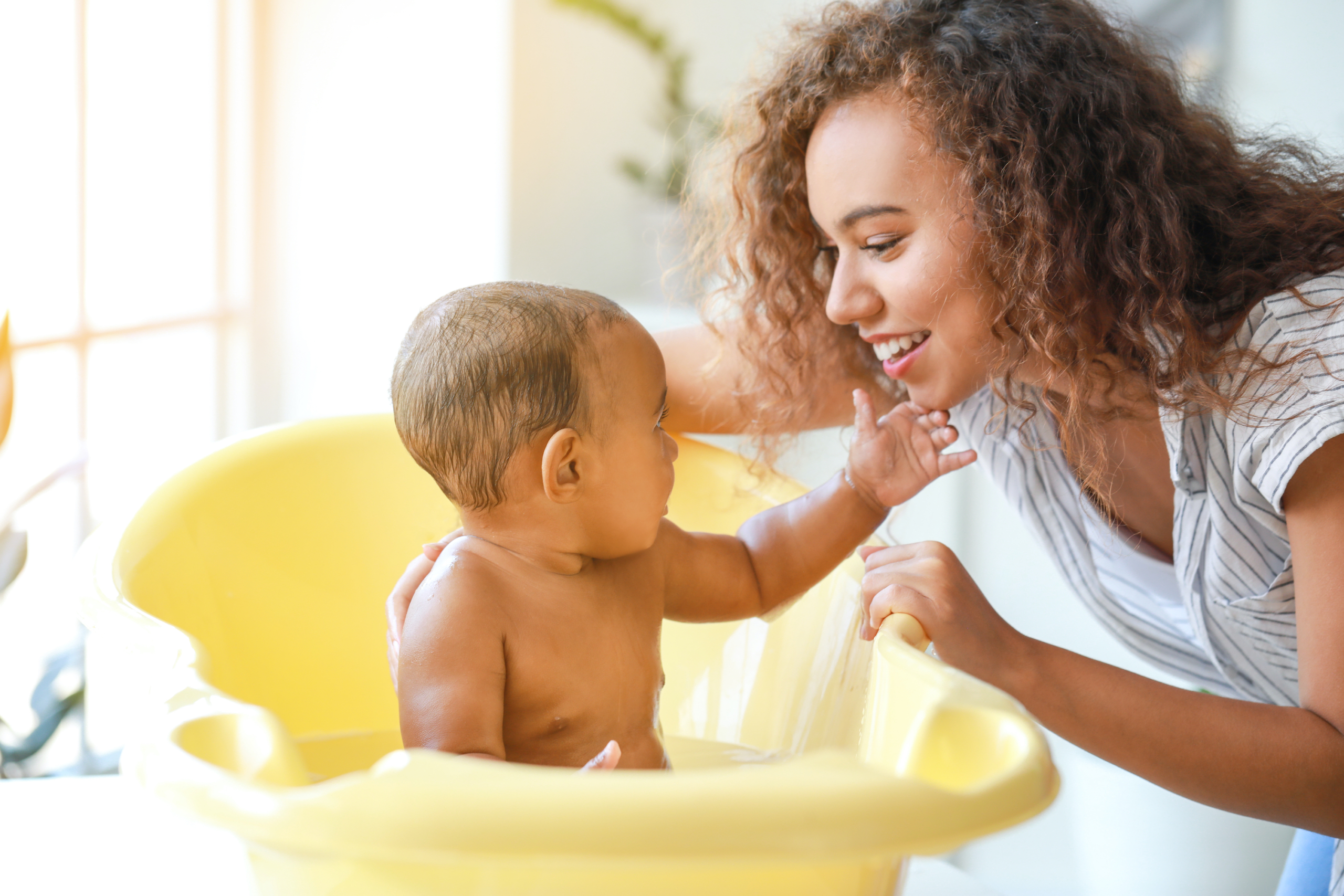 Mom giving baby a bath