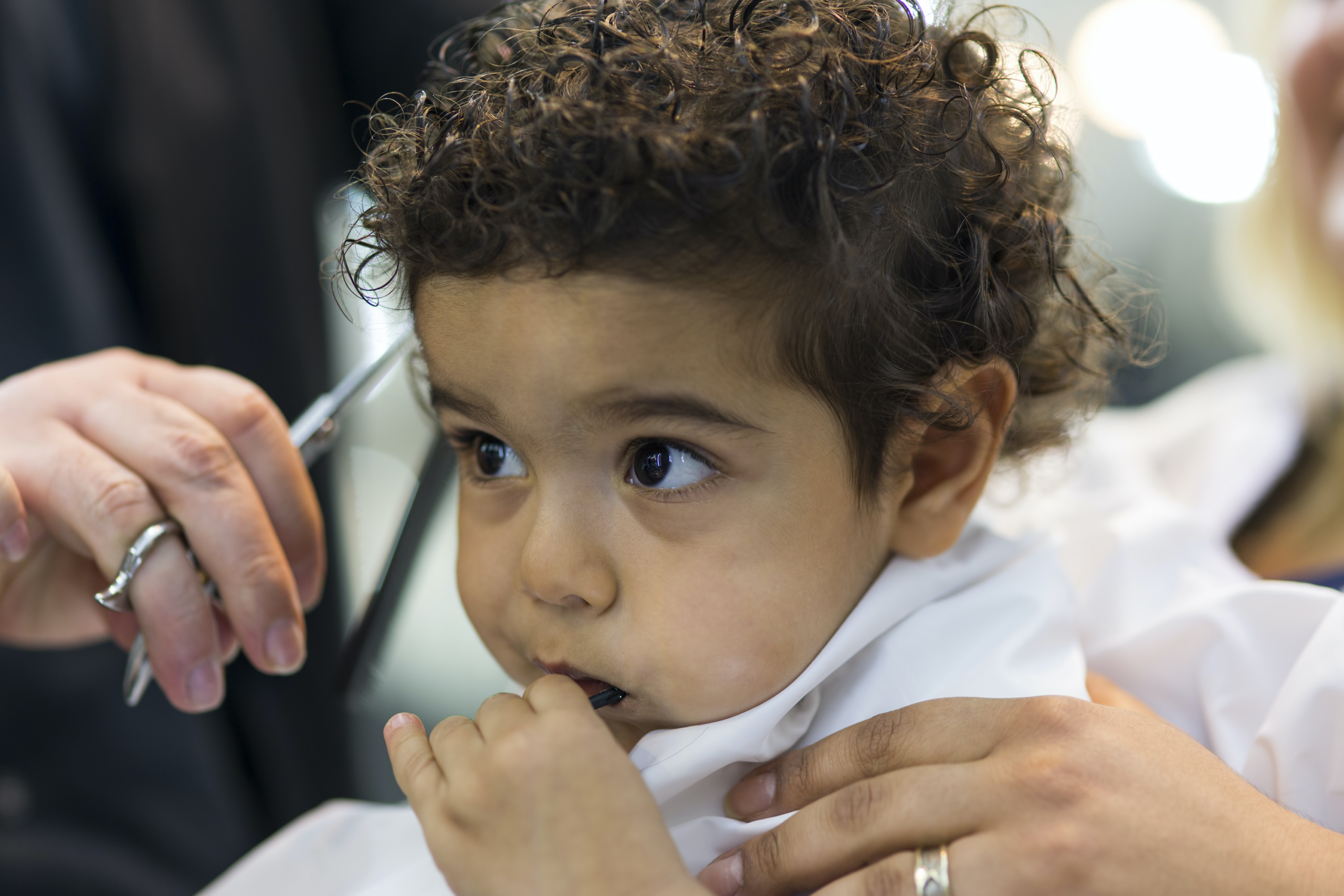 A baby getting their hair cut.