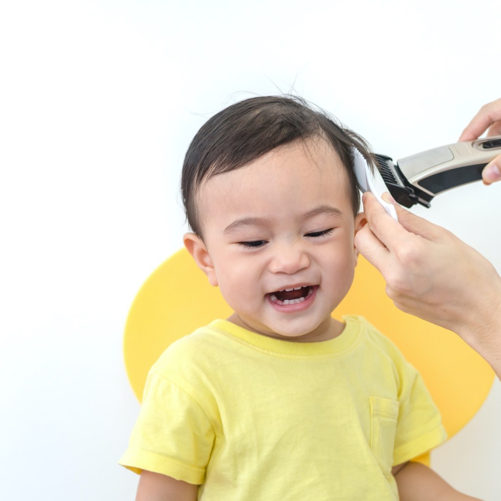 Baby getting a haircut.