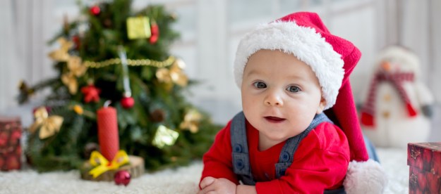 Baby in front of a Christmas tree