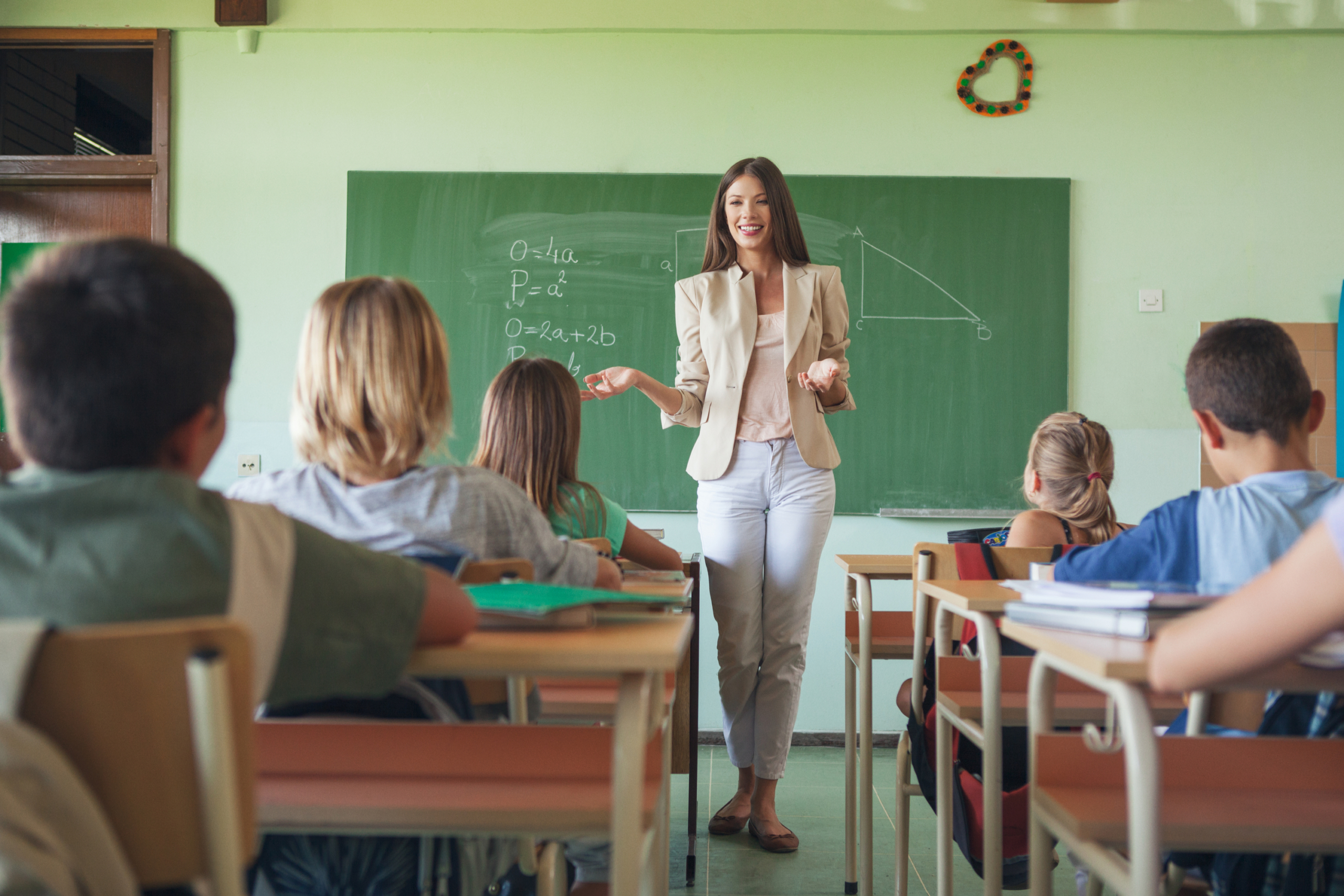 Female teacher teaching students in the classroom