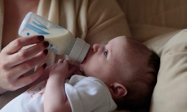 Baby drinking from a bottle.