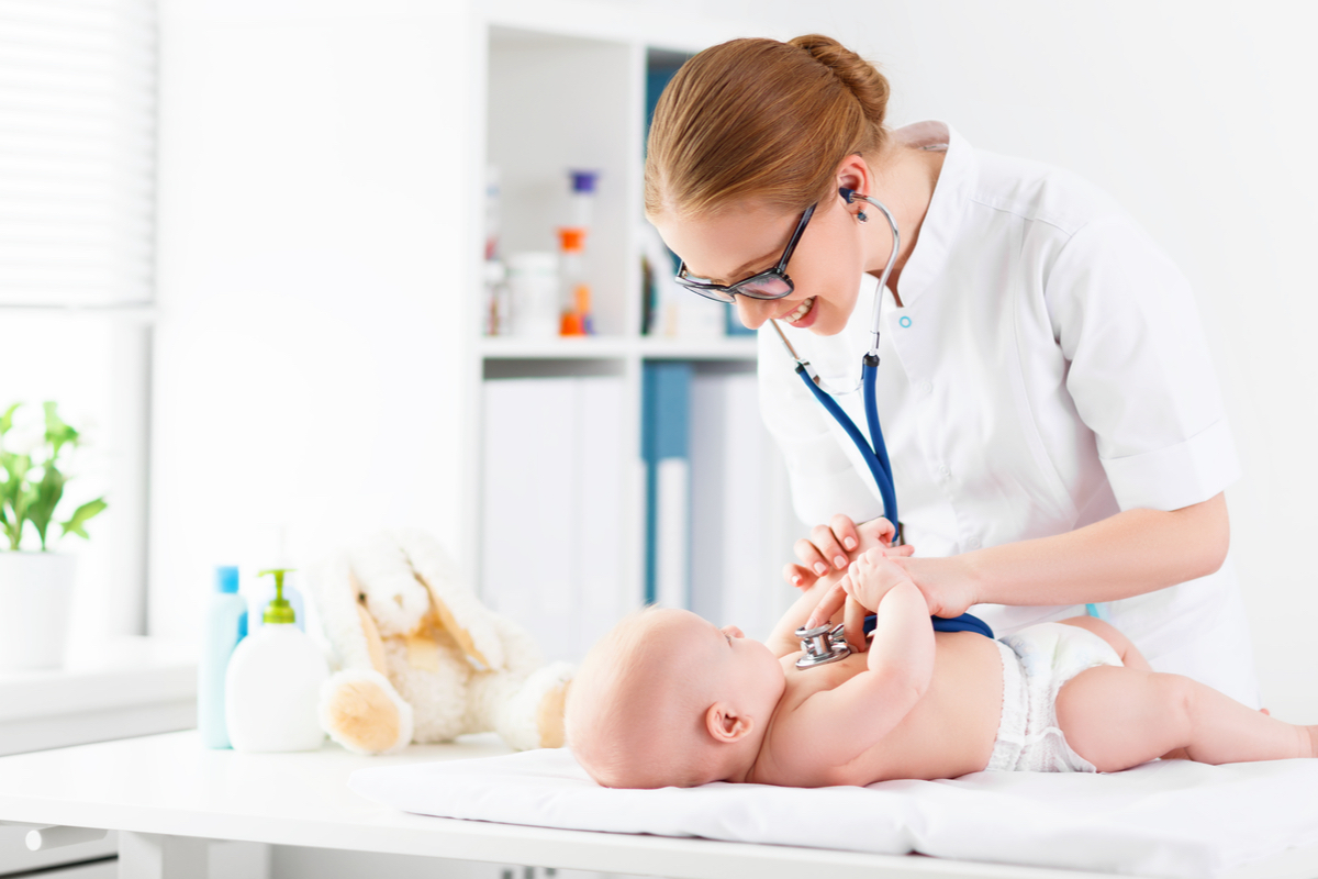 Female pediatrician examines a baby