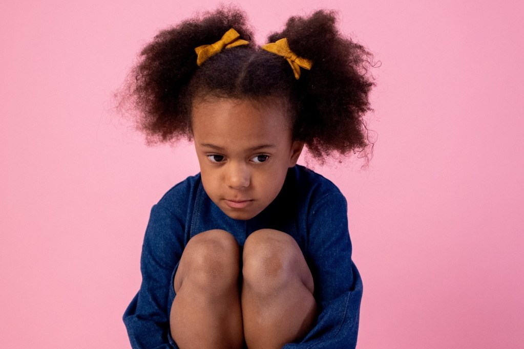 sad toddler in chair