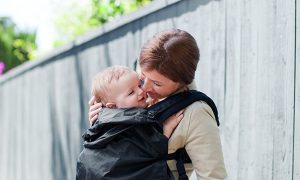 Mother with her baby in a carrier