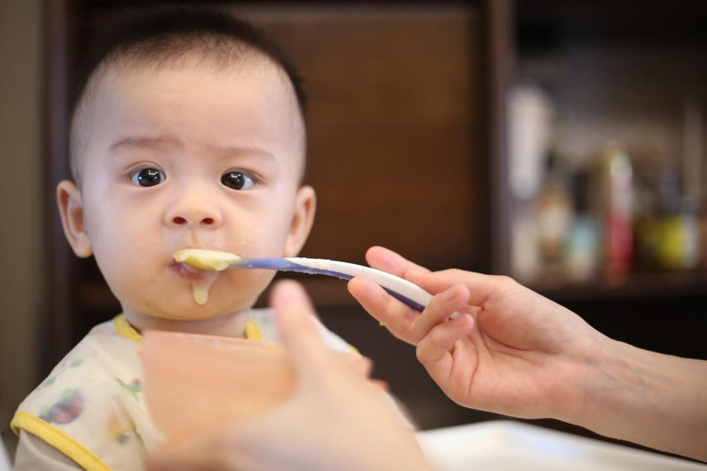 Baby being fed with spoon