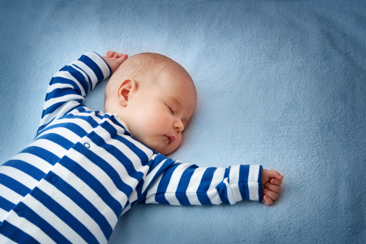 Baby sleeping on a bed