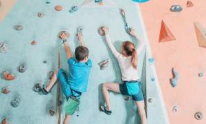 Kids scaling a rock wall