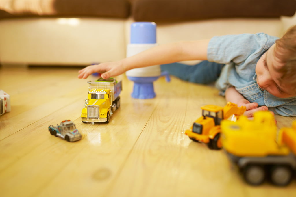 Toddler playing with trucks.