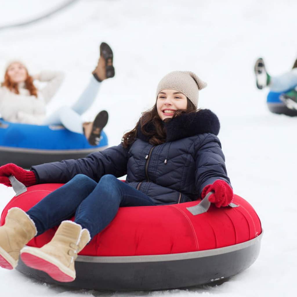 Girl sitting on a snow tube