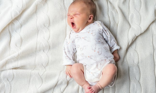 Tired baby yawning