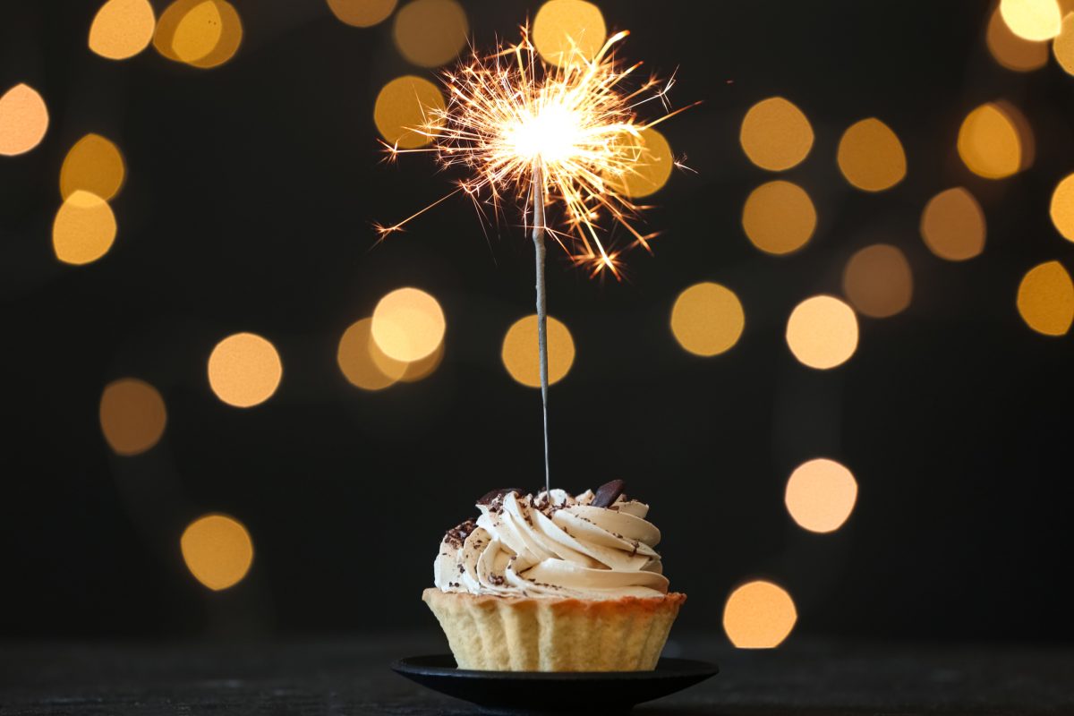 A cupcake with a sparkler in the middle