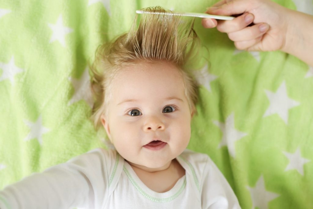 Baby getting their hair combed