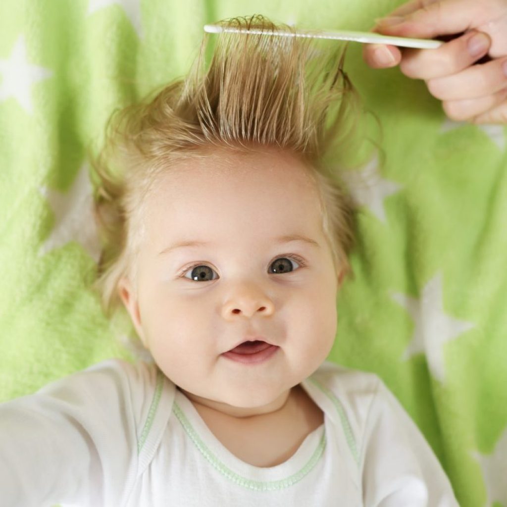 Baby getting hair combed.