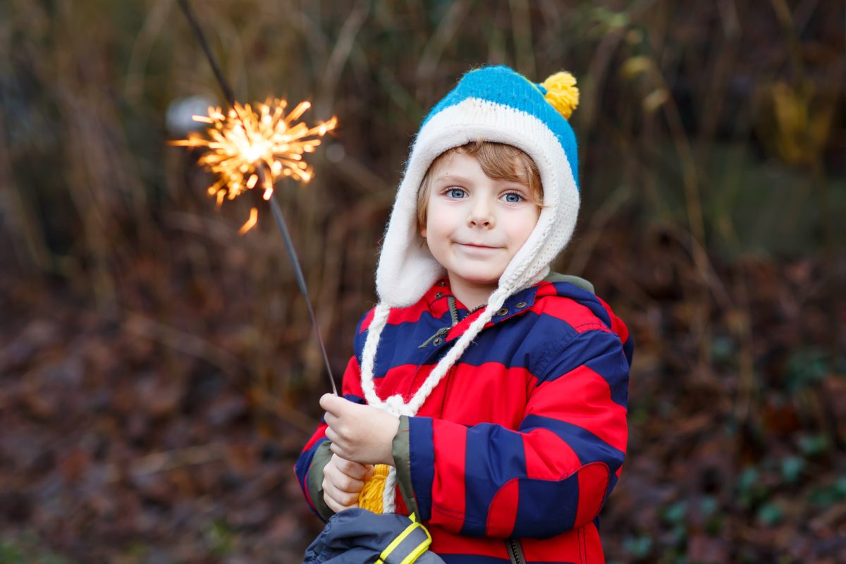 Toddler boy holds a sparkler