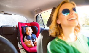 Mother looks at baby in car