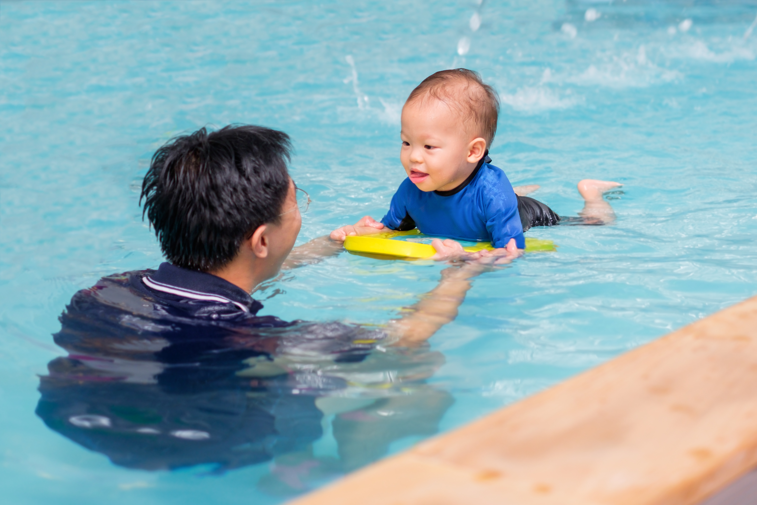 Baby boy in swimming lesson
