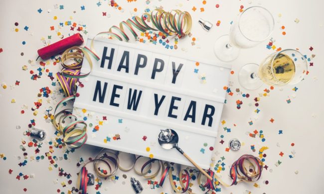 Happy New Year sign with confetti