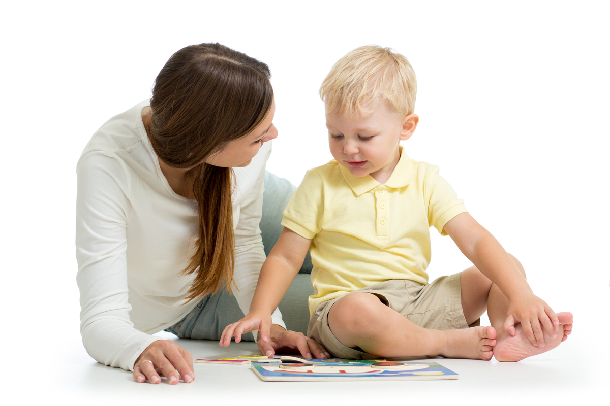 toddler doing a puzzle with mother