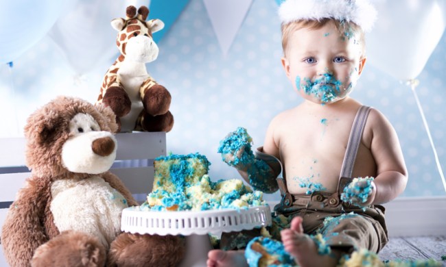 Baby boy enjoys his smash cake on his birthday