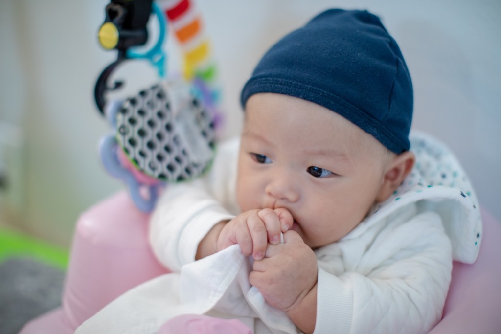 baby chewing on clothes